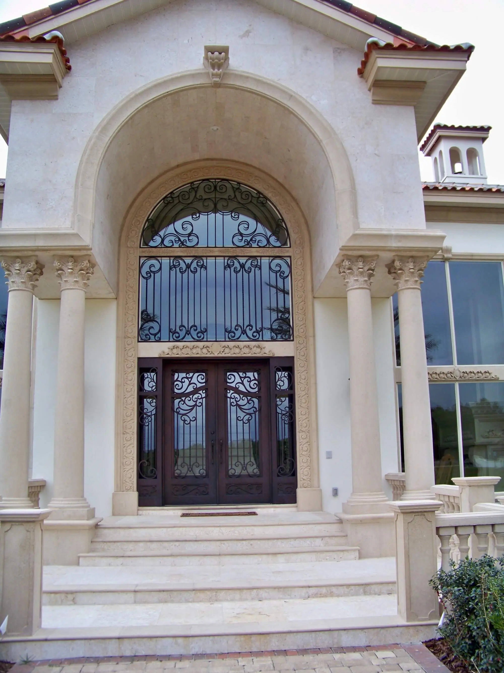 Large Front Entryway to Home with Stone Steps and Columns